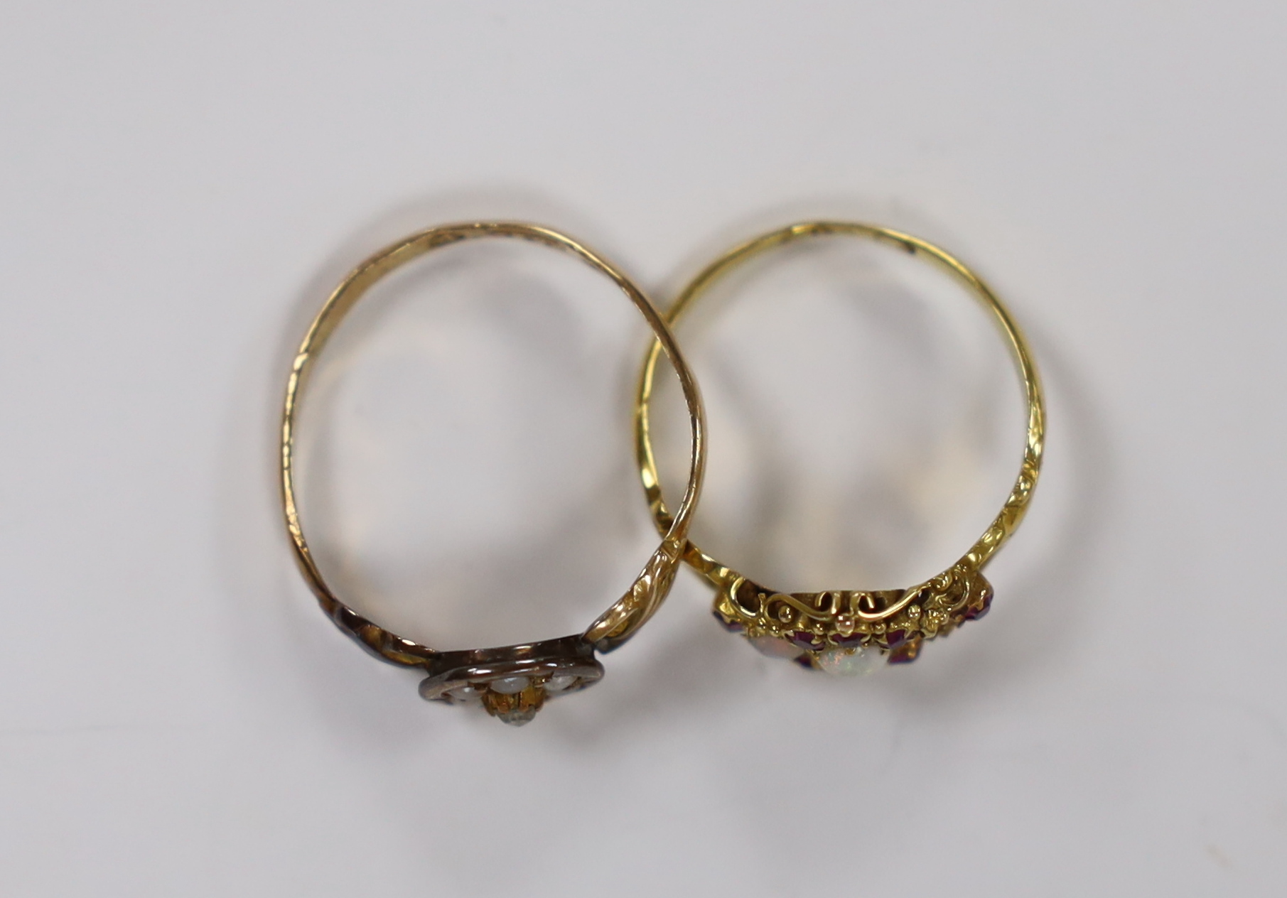 A Victorian 18ct gold, white opal and garnet cluster set dress ring, (opal missing), size J/K, gross weight 1.9 grams and a 15ct gold, seed pearl and rose cut diamond cluster set ring gross weight 1.7 grams.